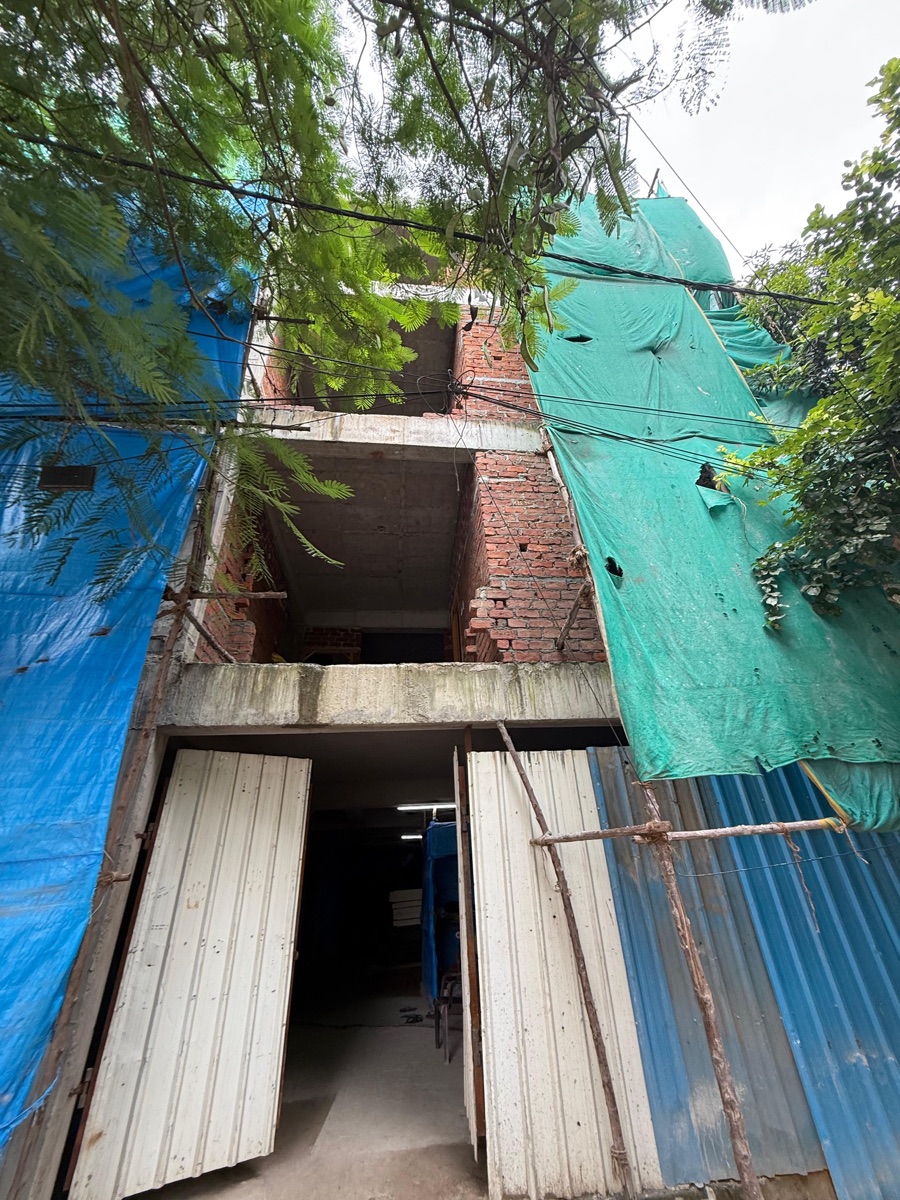 Brick and RCC construction site wrapped in safety netting, built with Clyft materials